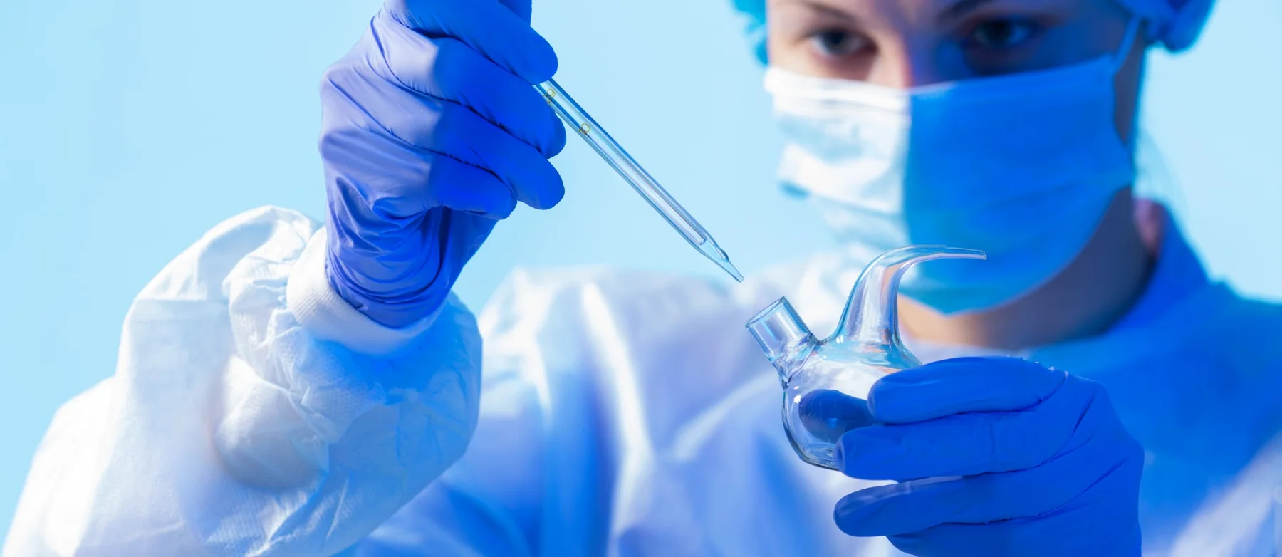 Laboratory researcher working with glassware