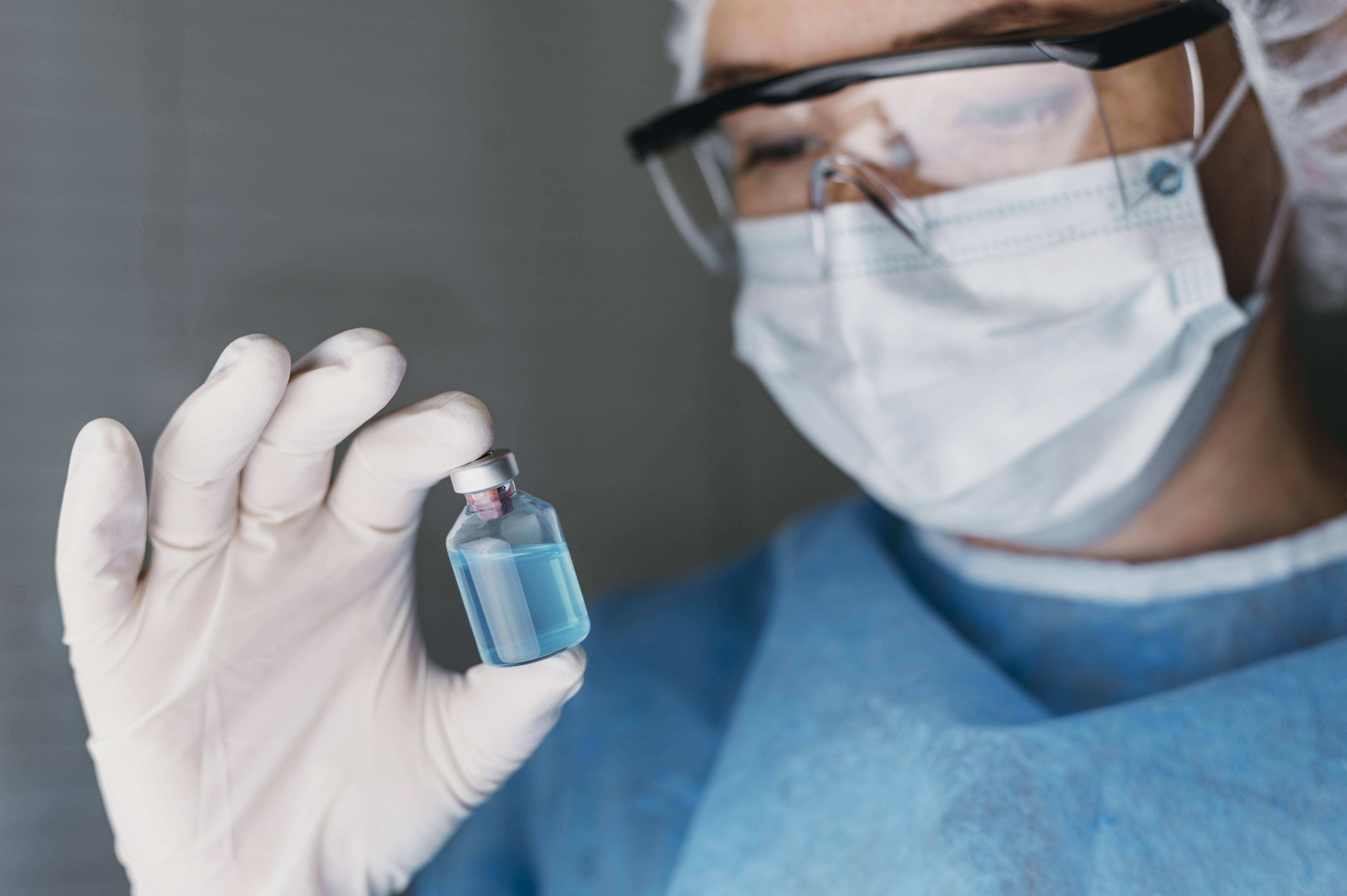 Research professional holding a vial